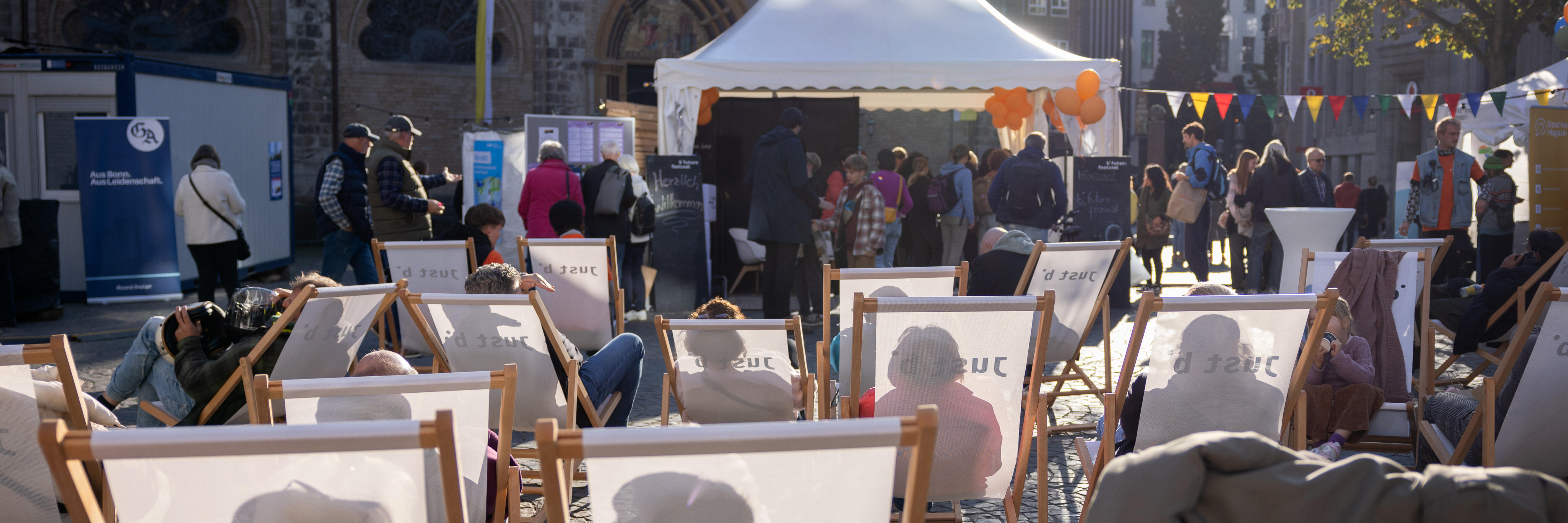 A tent on Münsterplatz, with lounge chairs set up in front of it.
