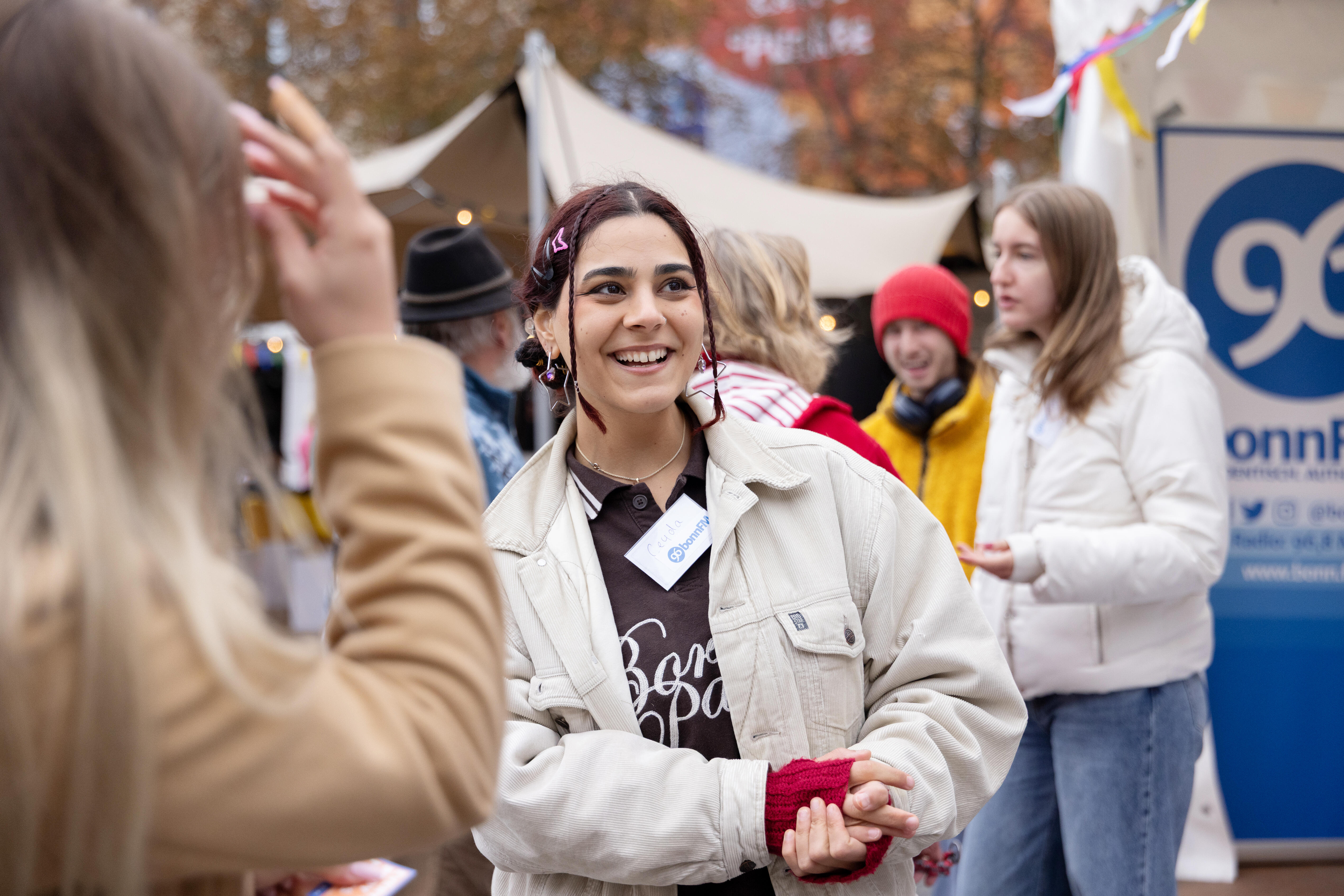 Festival visitors engaging in conversation with one another.